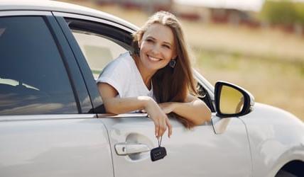 Women in newly bought leased car 